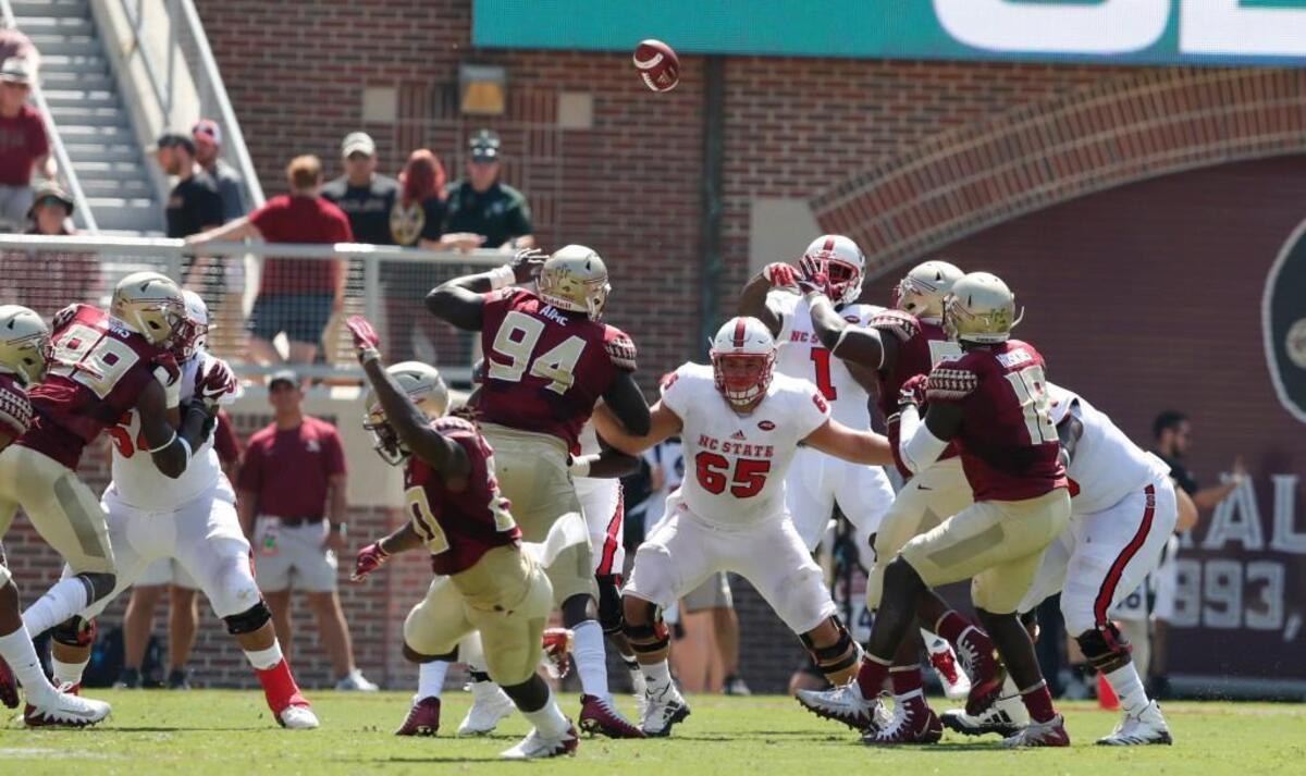 N.C. State's Jaylen Samuels (1) passes for a 25-yard completion to Dylan Parham during the Wolfpack’s game against Florida State at Doak Campbell Stadium in Tallahasee Saturday, Sept. 23, 2017.