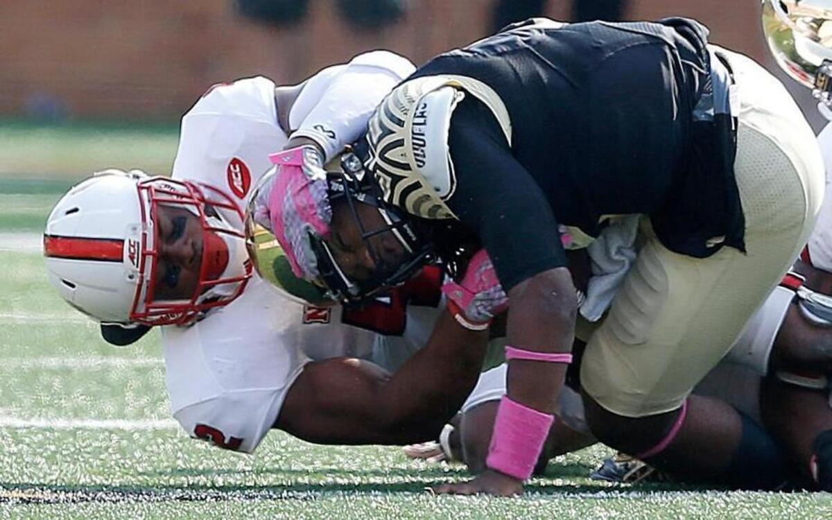 N.C. State’s M.J. Salahuddin (42) tackles Wake Forest quarterback Kendall Hinton (2) during the second half of N.C. State's 35-17 victory over Wake Forest at BB&T Field in Winston-Salem, N.C., Saturday, Oct. 24, 2015.