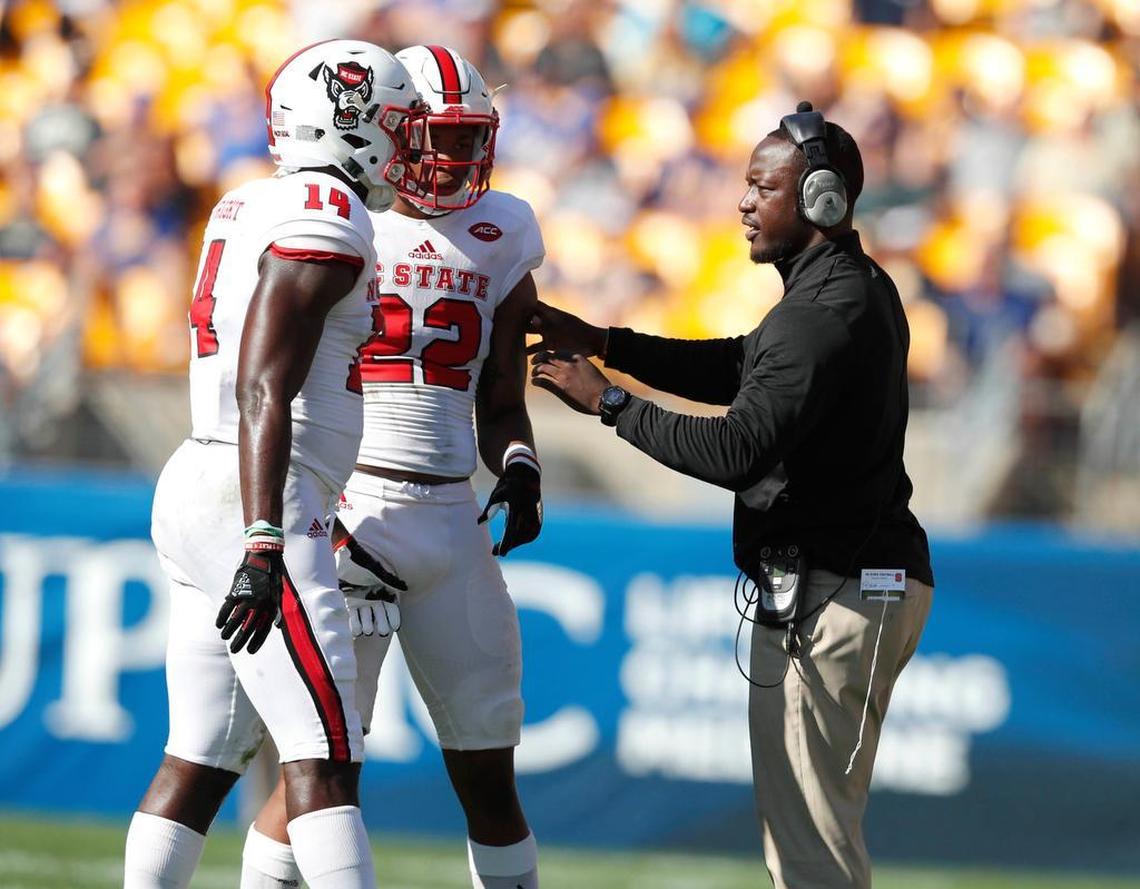 N.C. State safeties coach Aaron Henry talks with Isaiah Stallings (22) and Dexter Wright (14) during the Wolfpack's victory over Pittsburgh at Heinz Field in Pittsburgh on Oct. 14, 2017.