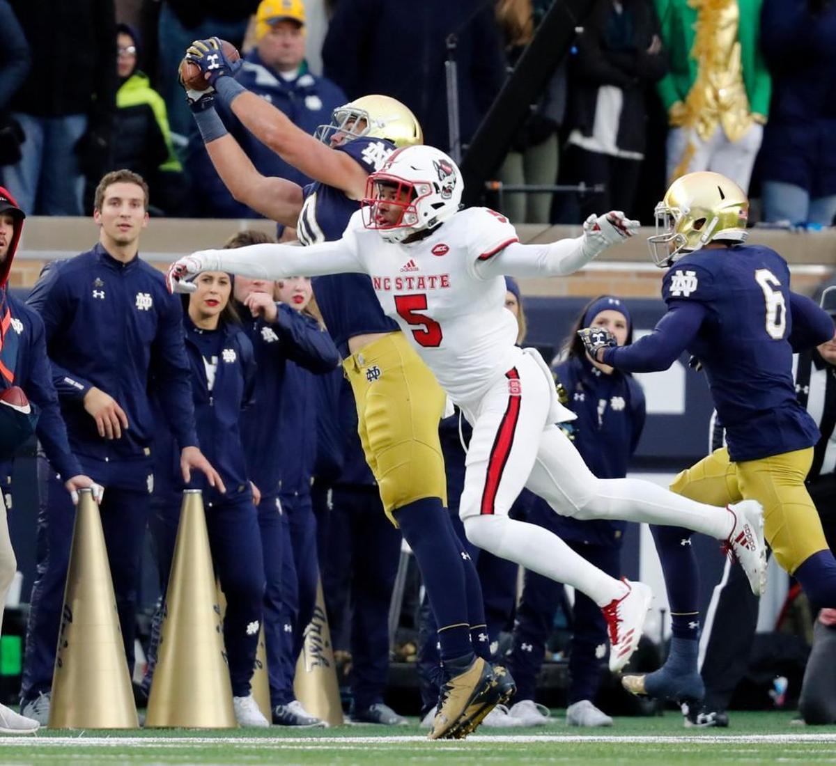 On third and six, Notre Dame tight end Durham Smythe (80) makes the catch, keeping his feet inbounds, as N.C. State cornerback Johnathan Alston (5) defends at Notre Dame Stadium in South Bend, Ind., Saturday, Oct. 28, 2017.