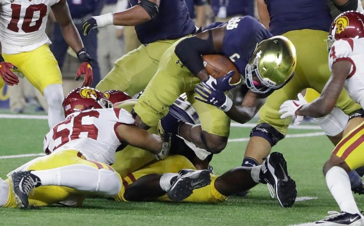 Notre Dame running back Josh Adams scores on a 3-yard run during the game against Southern California, Saturday, Oct. 21, 2017, in South Bend, Ind.