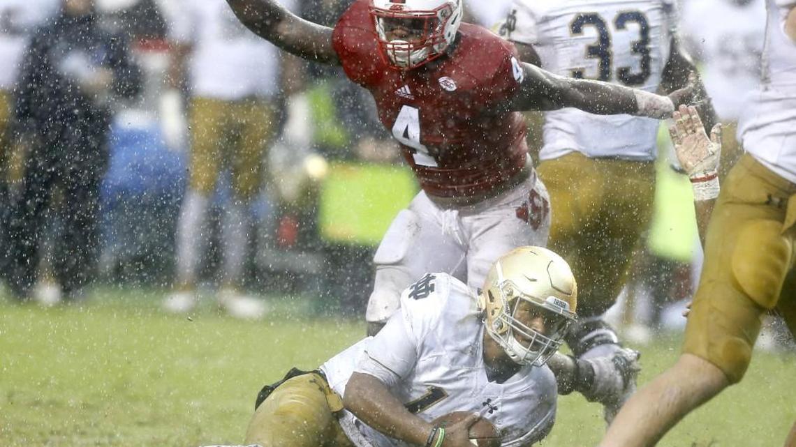 N.C. State linebacker Jerod Fernandez, middle, celebrates after Notre Dame quarterback DeShone Kizer, bottom, was sacked on Oct. 8. The ACC announced an extended football agreement with the Fighting Irish.