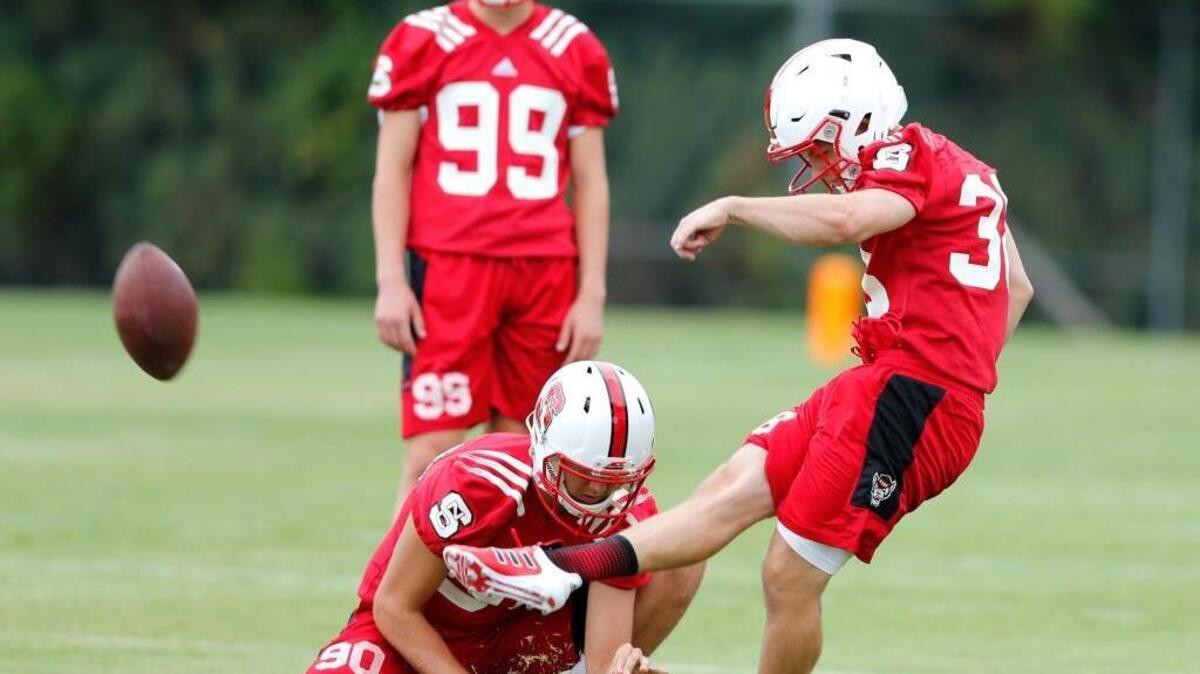 N.C. State's Carson Wise (38) kicks as A.J. Cole III (90 holds during the Wolfpack's first practice of fall camp at the Curtis and Jacqueline Dail Football Practice Complex on July 29, 2017.