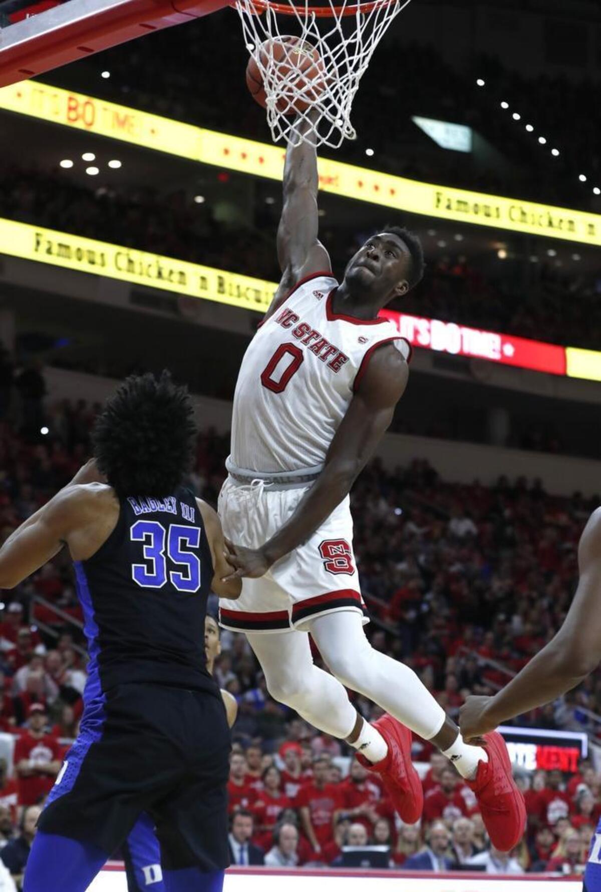 N.C. State's Abdul-Malik Abu (0) heads to slam in two over Duke's Marvin Bagley III (35) during the second half of N.C. State's 96-85 victory over Duke at PNC Arena on Jan. 6, 2018.