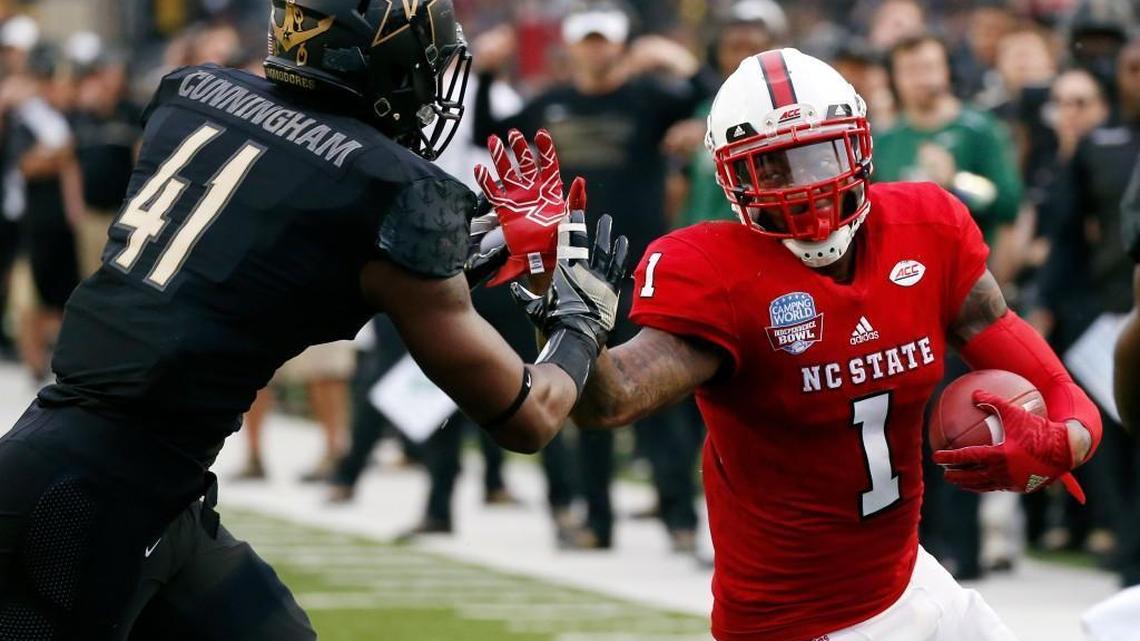 N.C. State tight end Jaylen Samuels, right, holds off Vanderbilt linebacker Zach Cunningham for a first-down pass reception in the Independence Bowl on Dec. 26. The Wolfpack won 41-17.