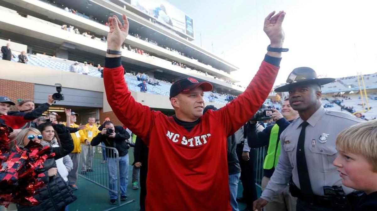
N.C. State head coach Dave Doeren celebrates after N.C. State's 35-7 victory over North Carolina at Kenan Stadium in Chapel Hill, N.C., Saturday, Nov. 29, 2014.
