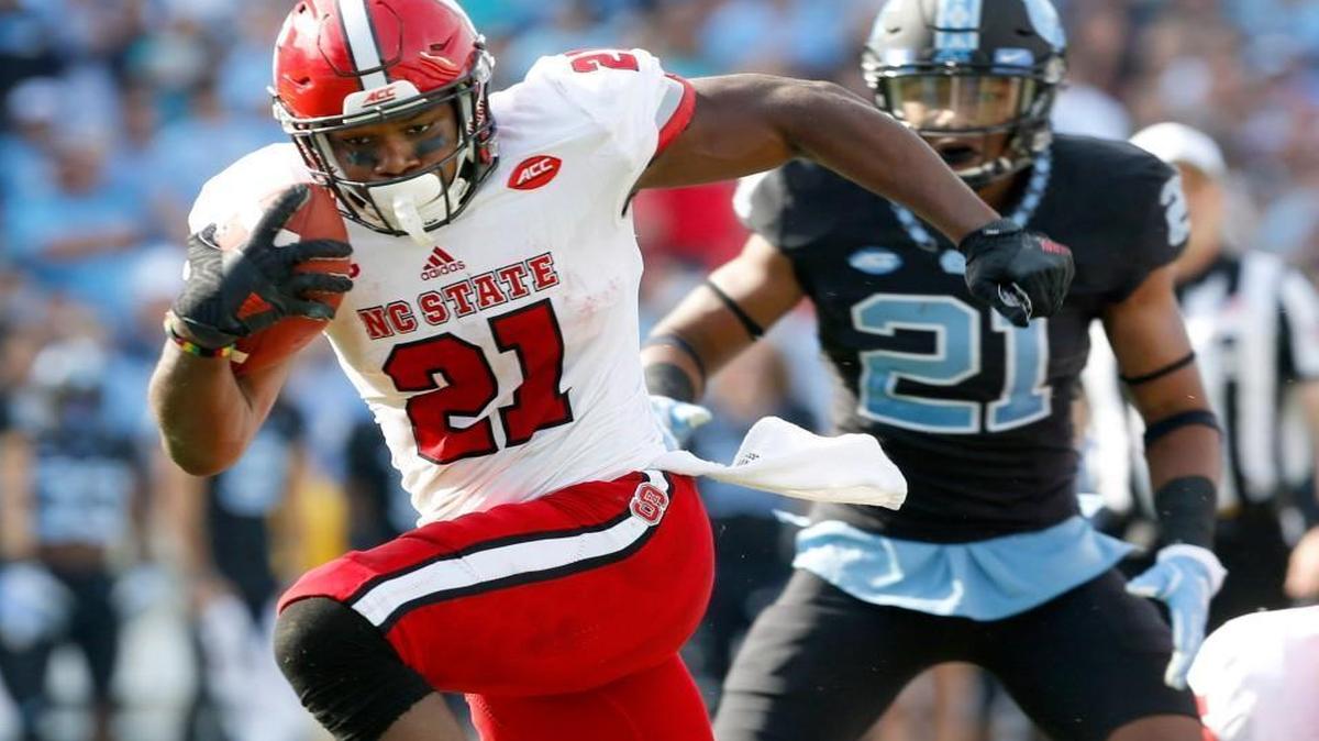 N.C. State running back Matt Dayes (21) breaks free for an 18-yard touchdown run during the Wolfpack's game against UNC at Kenan Stadium on Nov. 25, 2016.