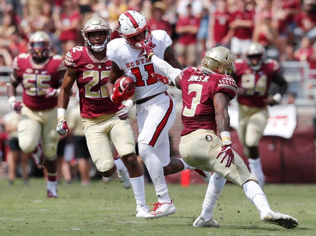 N.C. State wide receiver Jakobi Meyers (11) gets past Florida State defensive back Derwin James (3) on a 71-yard touchdown reception during the first half of N.C. State’s game against Florida State at Doak Campbell Stadium in Tallahassee on Sept. 23, 2017.