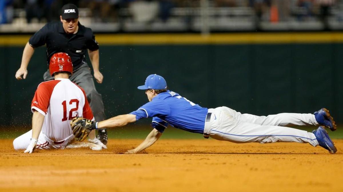 Kentucky’s Connor Heady dives to tag out NC State’s Brad Debo in the first inning in the NCAA baseball tournament on Monday.