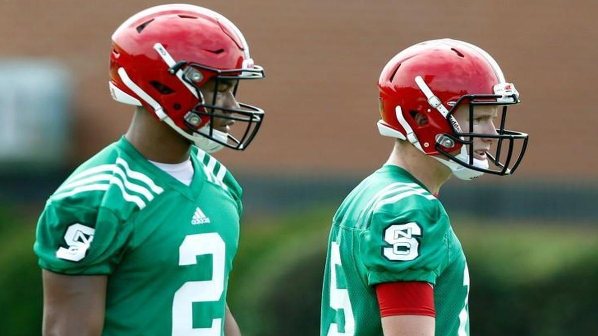 N.C. State quarterbacks Ryan Finley (15), right, and Jalan McClendon (2) run a drill during the Wolfpack's first practice of fall camp at the Dail Practice Complex in Raleigh, N.C., Monday, August 1, 2016.