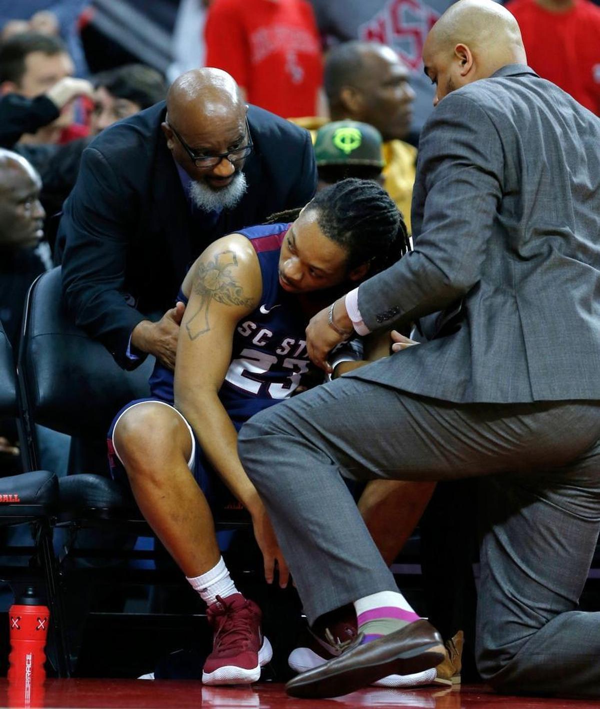 South Carolina State's Tyvoris Solomon (23) is attended to before he collapsed during the first half of N.C. State's game against South Carolina State.