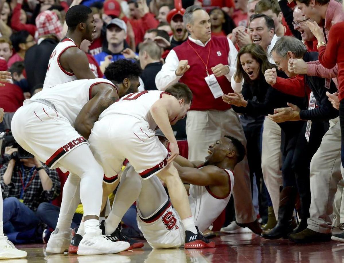 N.C. State guard Torin Dorn, on floor, is greeted by team members after he hit a 3-point shot and was fouled in the Wolfpack’s 96-85 win over No. 2 Duke on Jan. 6.