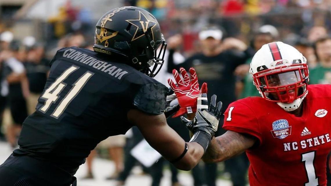 N.C. State tight end Jaylen Samuels, right, holds off Vanderbilt linebacker Zach Cunningham for a first-down pass reception in the Independence Bowl on Dec. 26. The Wolfpack won 41-17.