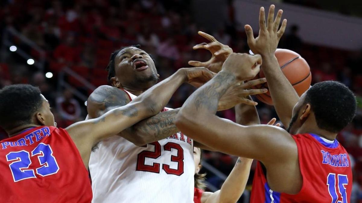 N.C. State's Ted Kapita is fouled as he pulls in a rebound between St. Francis College's Darelle Porter, left, and Jahmel Bodrick during the first half at PNC Arena.