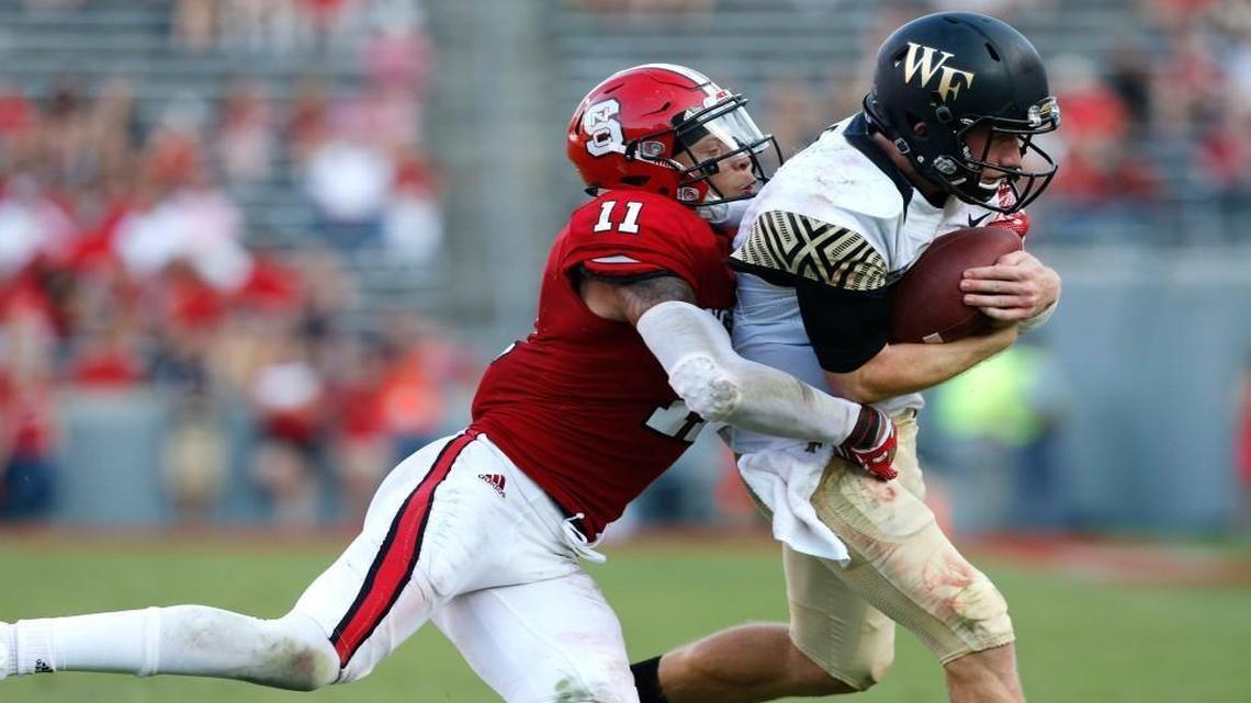 N.C. State safety Josh Jones, left, tackles Wake Forest quarterback John Wolford during the Wolfpack’s 33-16 win over Wake Forest on Oct. 1. Jones has decided to skip his senior season and enter the NFL draft.