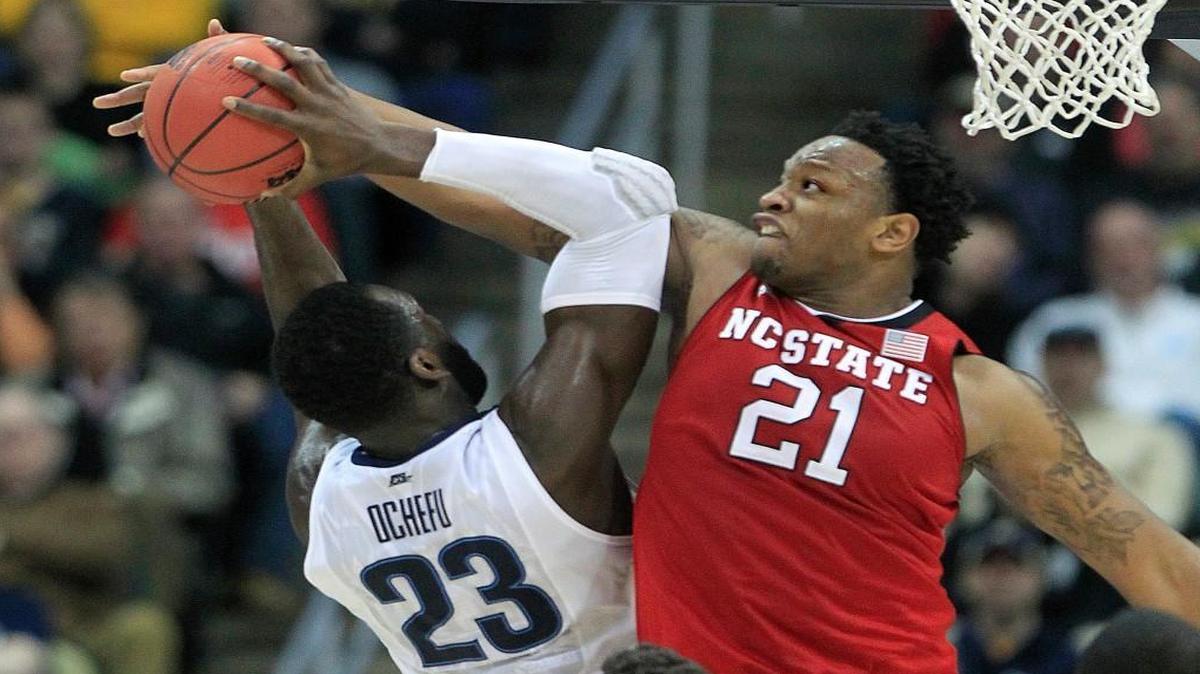 N.C. State's BeeJay Anya (21) stops the shot by Villanova's Daniel Ochefu (23) during the first half of the Wolfpack's game against Villanova in the third round NCAA Division I Men's Basketball Tournament at the Consol Energy Center in Pittsburgh, Pa. Saturday, March 21, 2015.