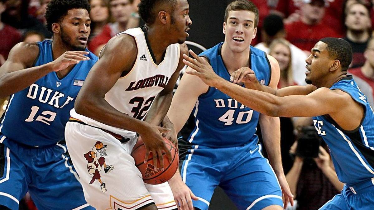 Duke defenders forward Justise Winslow (12), center Marshall Plumlee (40) and guard Matt Jones (13) converge on Louisville center Chinanu Onuaku (32) in the first half of play. Duke upset Louisville 63-52 at the KFC Yum! Center in Louisville, Ky., last January.