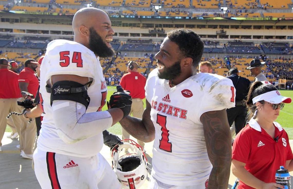 N.C. State offensive tackle Will Richardson (54) celebrates with Jaylen Samuels (1) as time runs out in the game during N.C. State’s 35-17 victory over Pittsburgh at Heinz Field in Pittsburgh on Saturday, Oct .14, 2017.