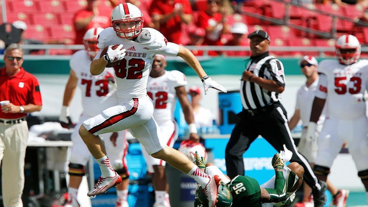 
N.C. State wide receiver Bo Hines (82) gets past South Florida defensive back Nate Godwin (36) during the Wolfpack's game against South Florida at Raymond James Stadium in Tampa, Fla., Saturday, September 13, 2014.

