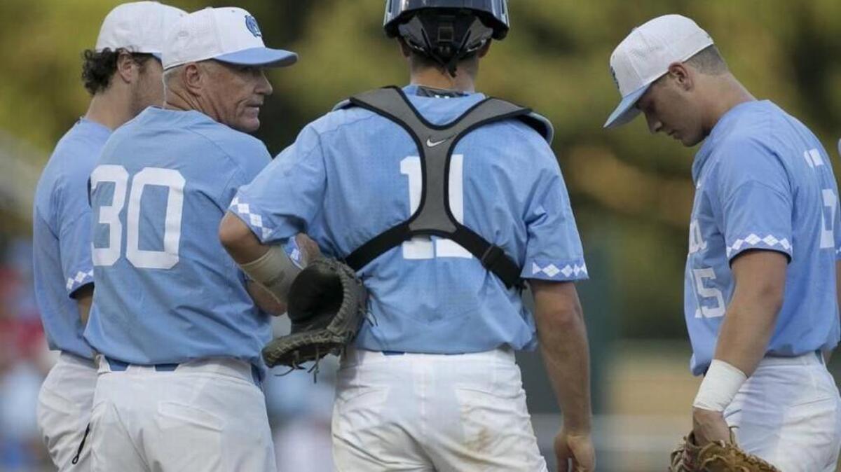 North Carolina coach Mike Fox confers with catcher Cody Roberts (11) and Michael Busch (15) after making a pitching change in the fifth inning against Davidson on Friday.