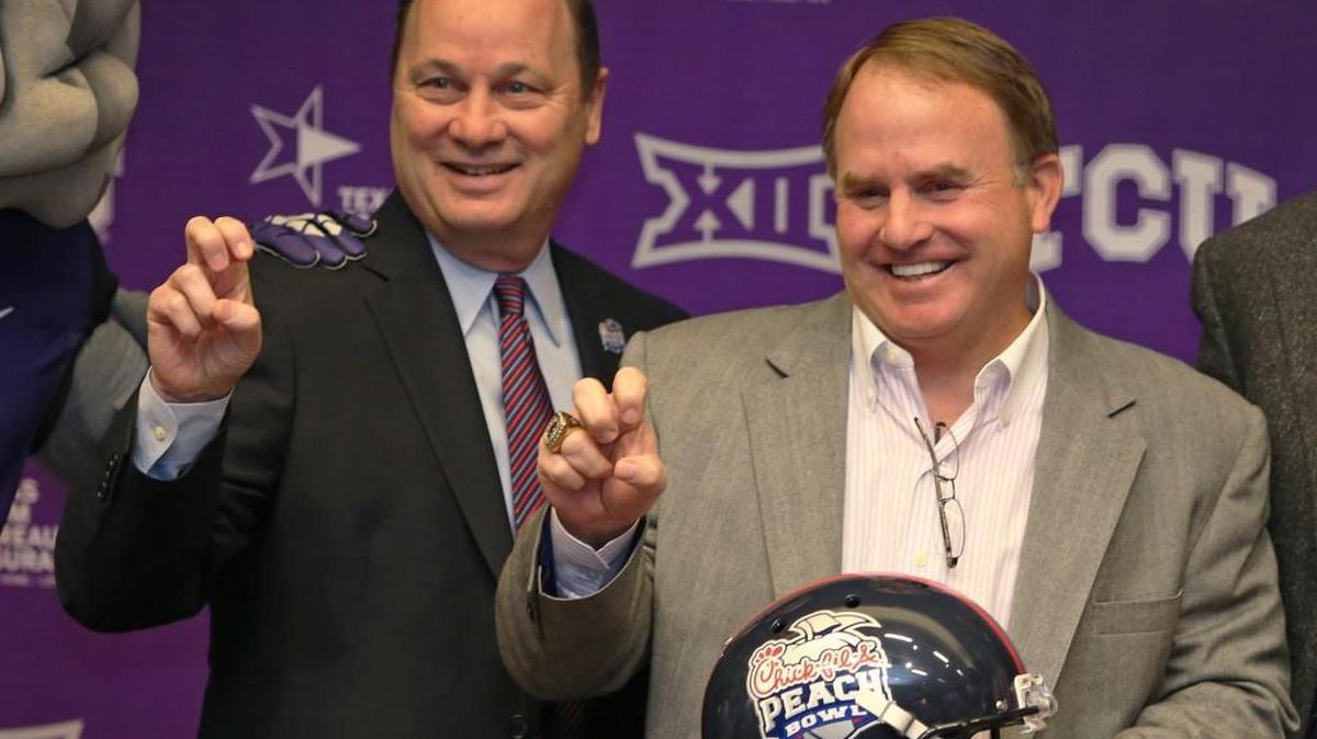 Gary Stokan, left, president and CEO of Peach Bowl, Inc., stands with TCU’s head football coach Gary Patterson in 2014.