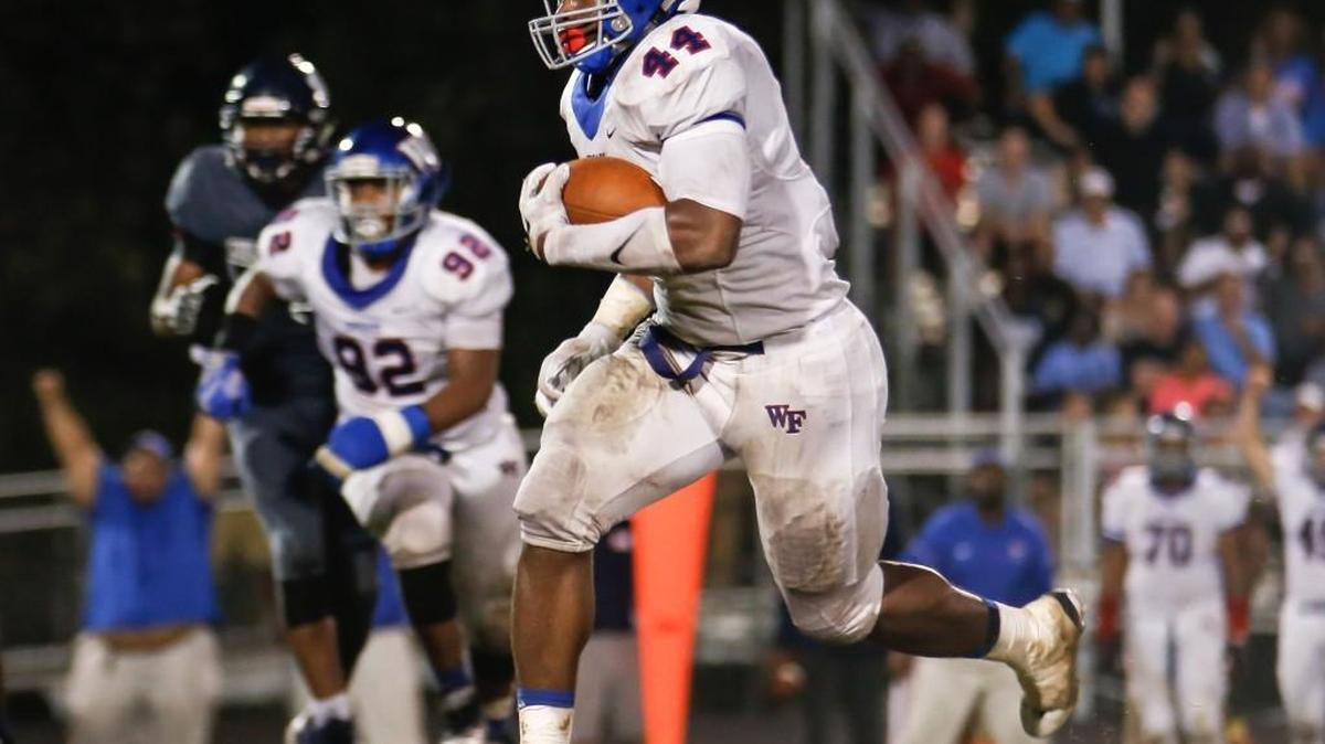 Wake Forest defender Darius Hodge (44) returns an interception during Wake Forest’s football game at Millbrook on Sept. 30. Wake Forest won 37-0.