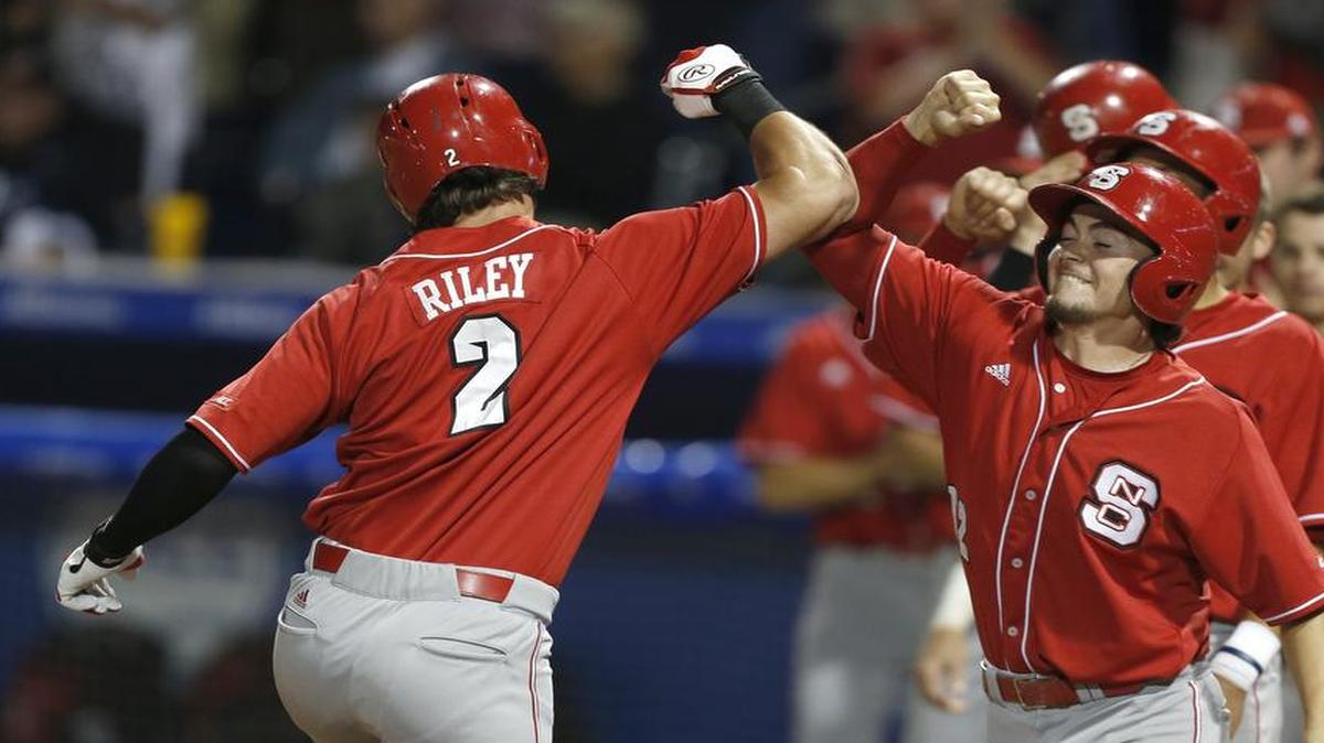 
N.C. State's Bubby Riley (2) comes home after hitting a grand slam home run in the eighth inning against Virginia in the ACC baseball tournament Saturday in Durham.
