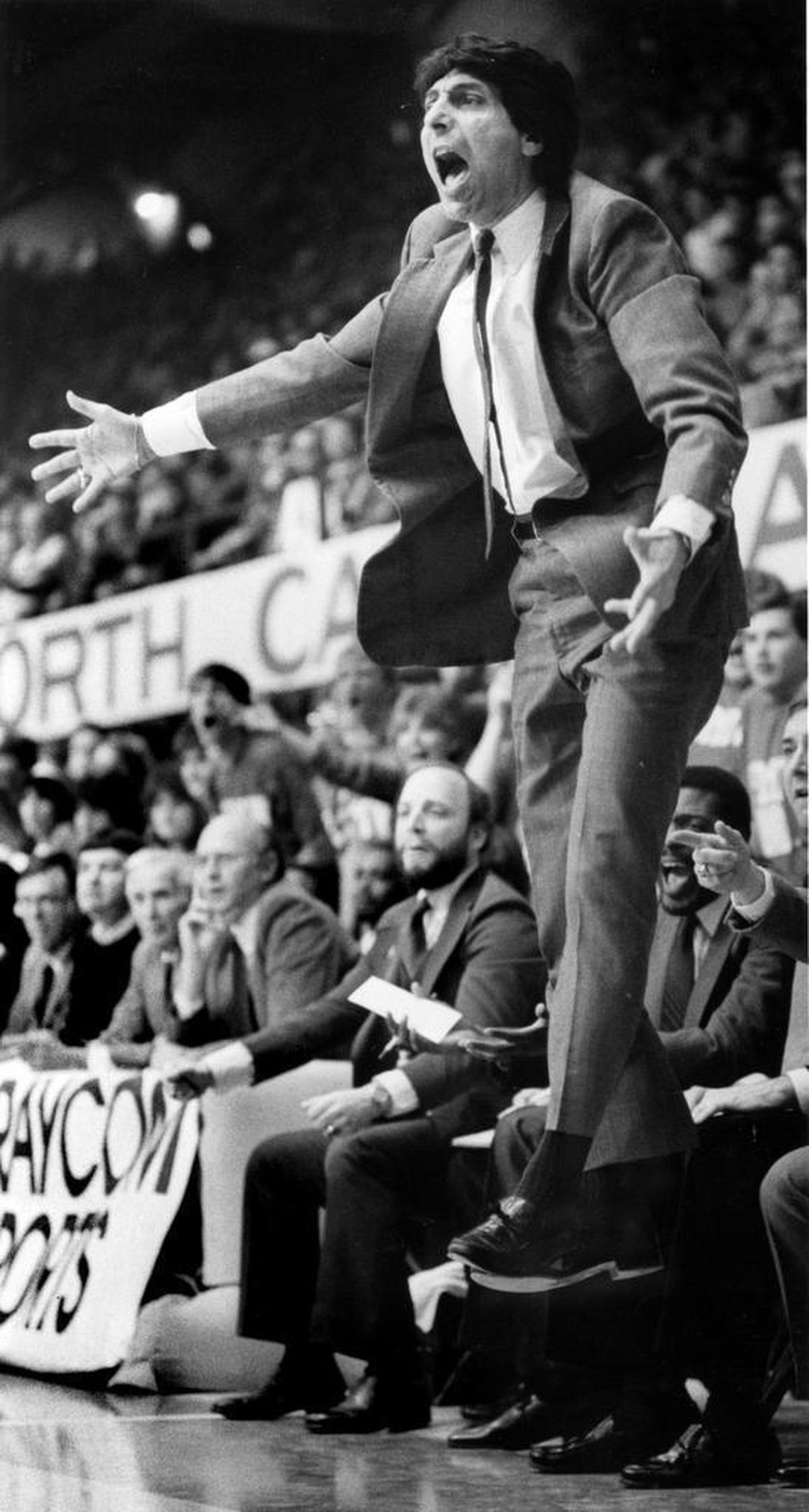 NC State coach Jim Valvano leaps during the Wolfpack's 85-76 victor over UNC on Feb. 17, 1985.