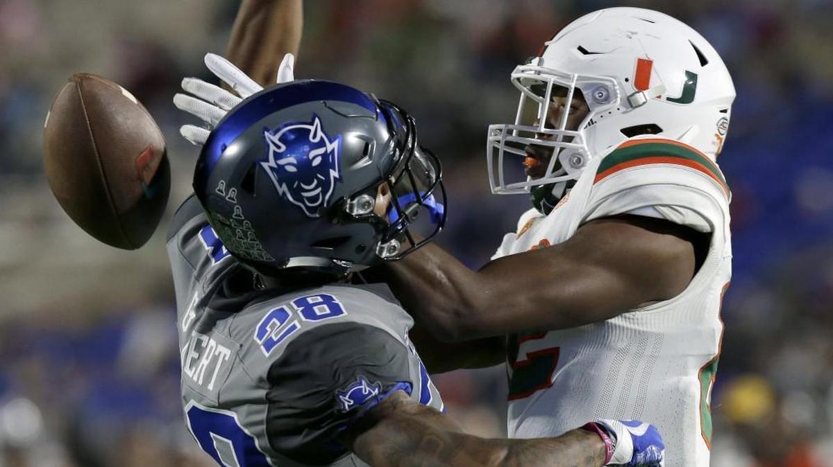Miami’s Ahmmon Richards, right, reaches for a pass broken up by Duke’s Mark Gilbert onn Dec. 5. The ACC on Wednesday announced its 2018 football schedule.