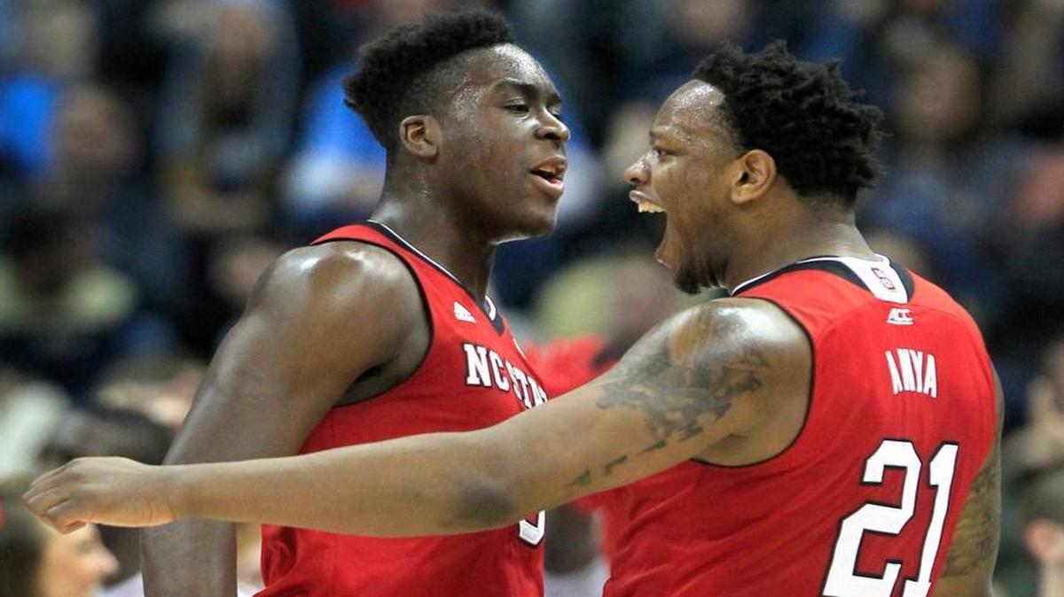 N.C. State's BeeJay Anya (21), right, celebrates with Abdul-Malik Abu (0) after Anya blocked a shot during the Wolfpack's game against Villanova in the third round NCAA Division I Men's Basketball Tournament at the Consol Energy Center in Pittsburgh, Pa. Saturday, March 21, 2015.