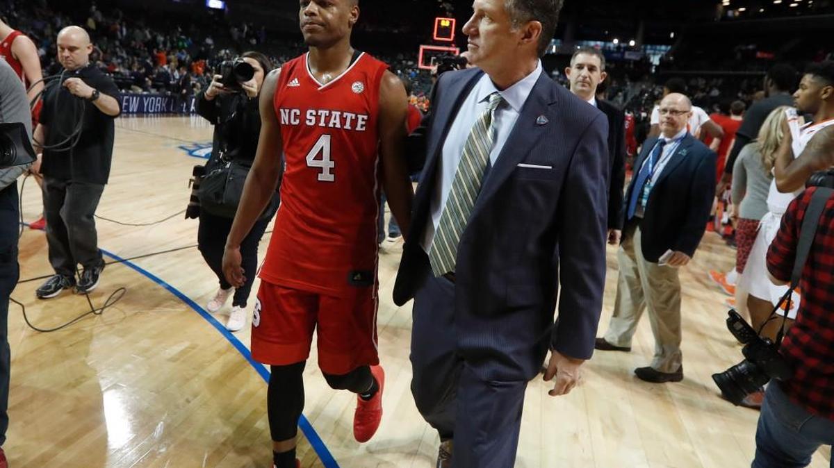 N.C. State’s head coach Mark Gottfried walks off the floor with Dennis Smith Jr. (4) after the Wolfpack’s 75-61 loss to Clemson in the first round of the ACC tournament on Tuesday.