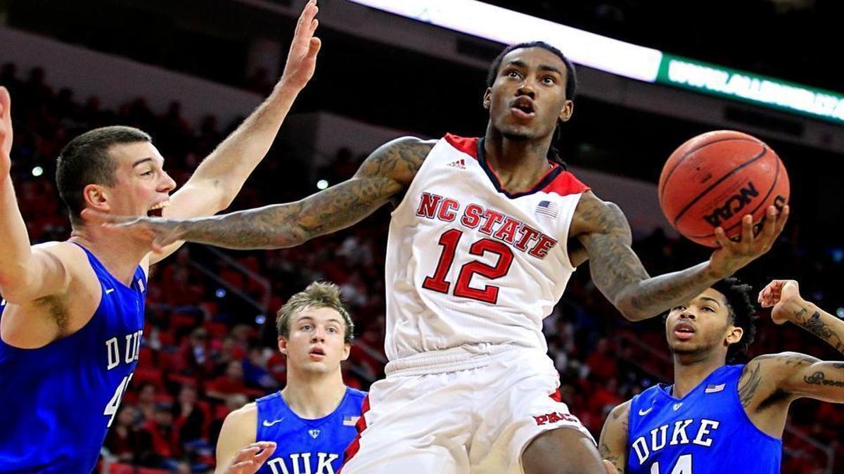 N.C. State's Cat Barber (12) drives to the basket past Duke's Marshall Plumlee (40) during the game at PNC Arena in January.