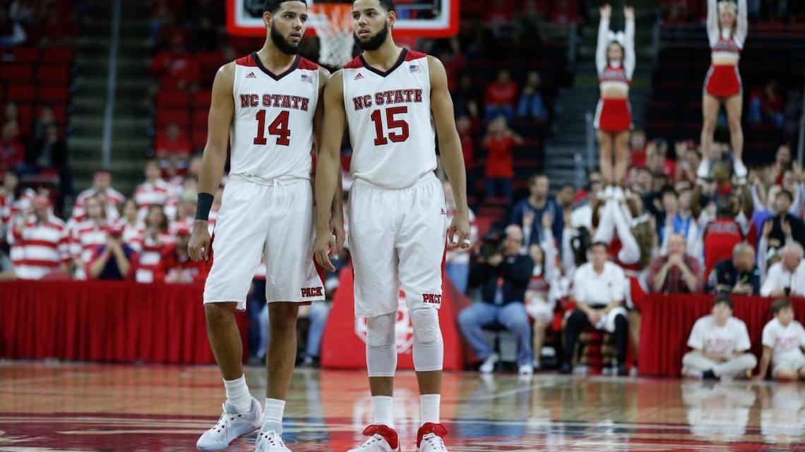 N.C. State's Caleb Martin (14), left, and Cody Martin (15) talk during the second half of N.C. State's 88-70 victory over South Alabama at PNC Arena in Raleigh, N.C., Sunday, Nov. 15, 2015.
