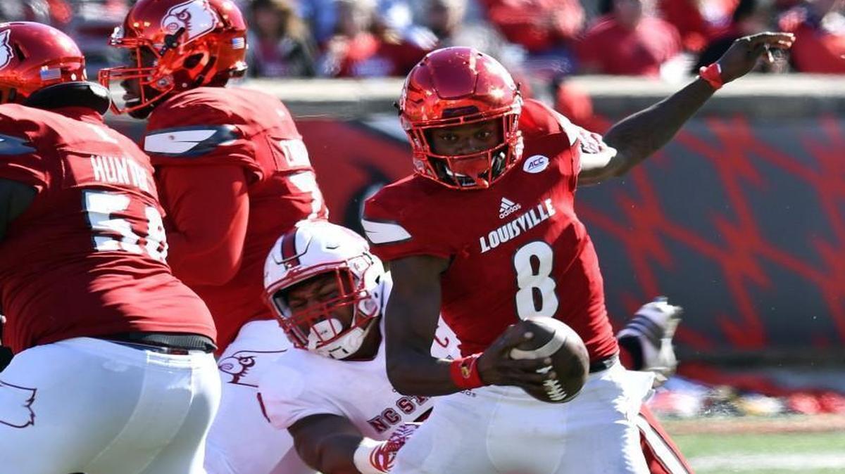 Louisville quarterback Lamar Jackson (8) avoids the sack attempt of N.C. State's Bradley Chubb (9) during the second half.