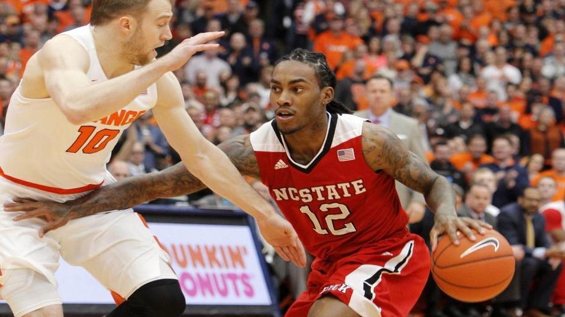 North Carolina State’s Anthony Barber, right, tries to get past Syracuse’s Trevor Cooney, left, in the first half of an NCAA college basketball game in Syracuse, N.Y.,.
