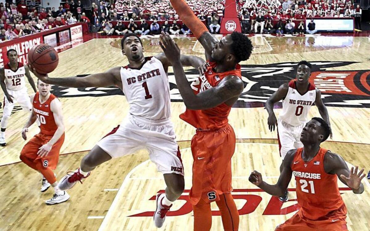
N.C. State's Trevor Lacey (1) shoots as Syracuse's Rakeem Christmas (25) defends in the second half during N.C. State's 71-57 victory over Syracuse at PNC Arena in Raleigh on Saturday, March 7, 2015.
