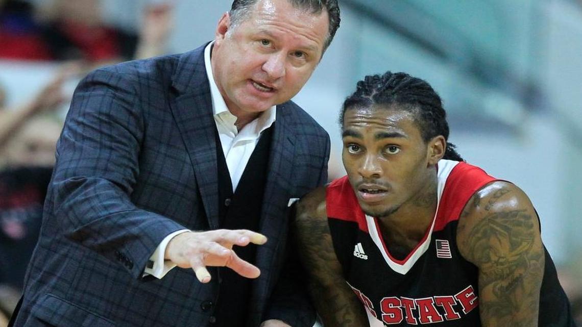 N.C. State head coach Mark Gottfried talks with Cat Barber (12) during the first half of the Wolfpack's game against Louisville at PNC Arena on January 7.
