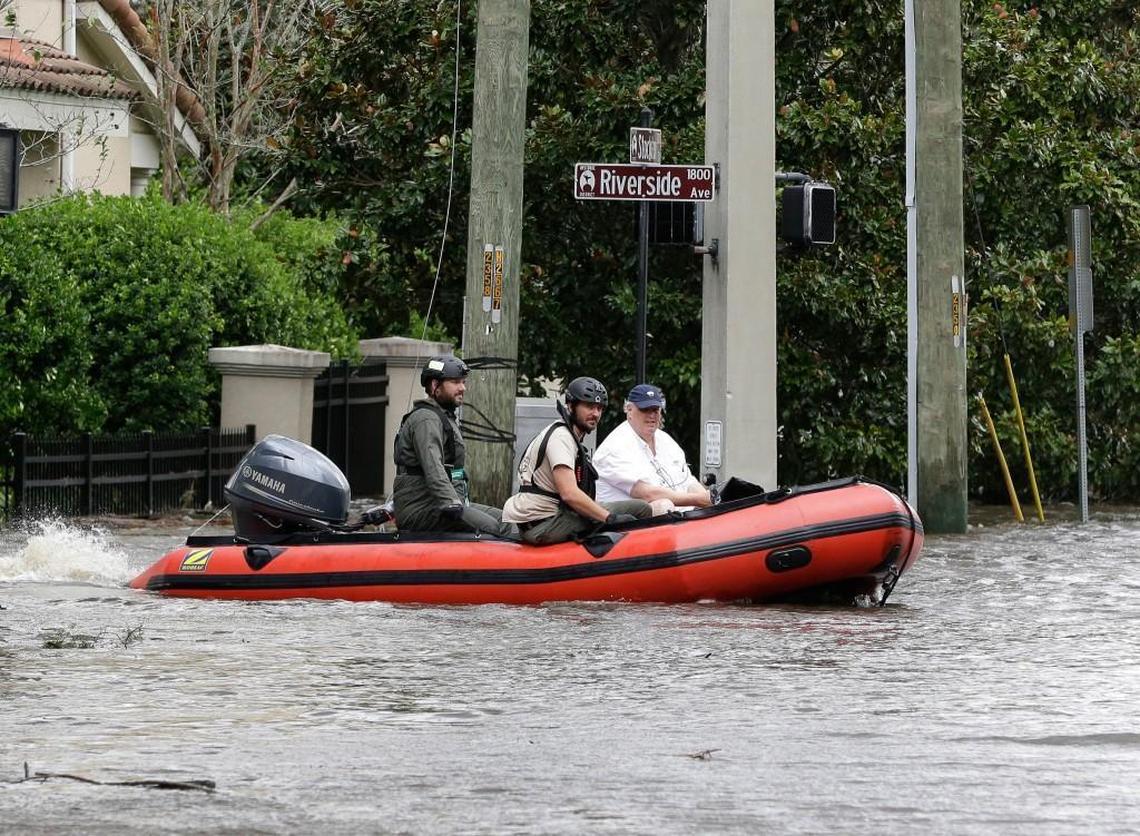 Rescue workers help Tom Purdy, right, evacuate his home after Hurricane Irma brought flood waters to Jacksonville, Fla. on Monday.