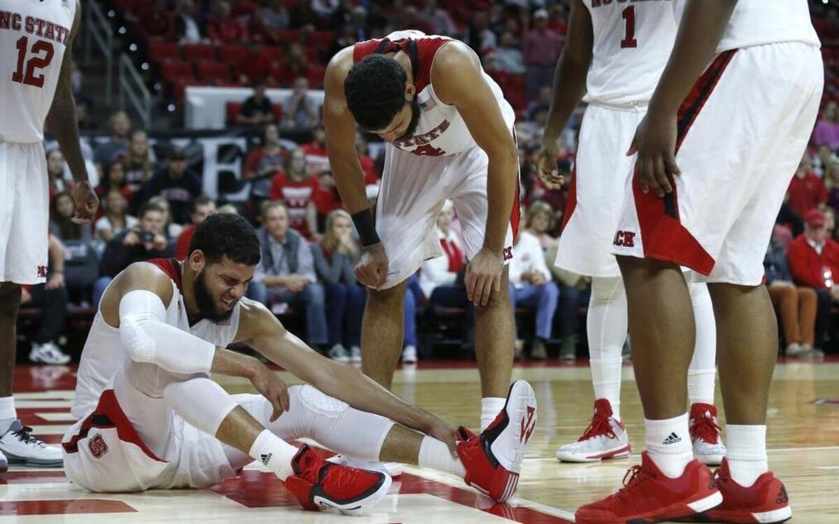 N.C. State’s Caleb Martin (14), right, checks on his brother Cody Martin (15) after he was injured during the second half of N.C. State’s 76-73 victory over High Point University at PNC Arena on Wednesday.
