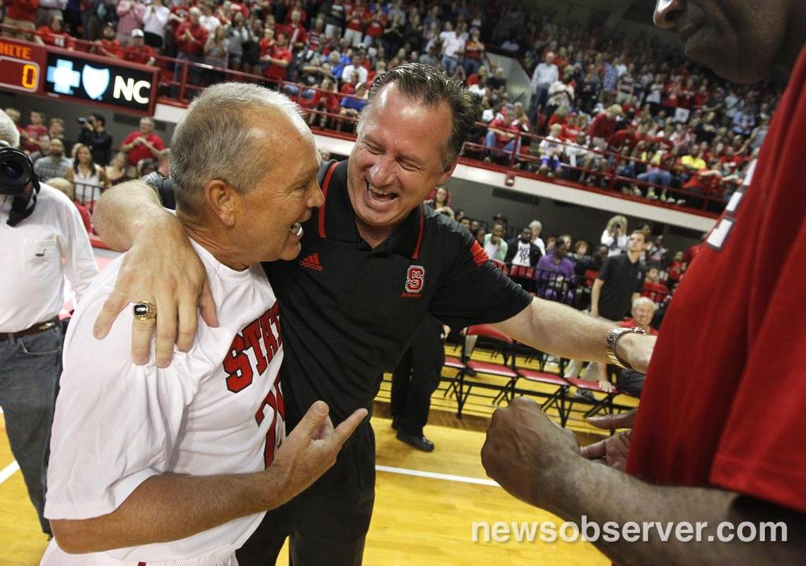 N.C. State's Mark Gottfried laugh with Monte Towe before the alumni game during N.C. State basketball's Throwback with the Pack at Reynolds Coliseum October 17, 2014.