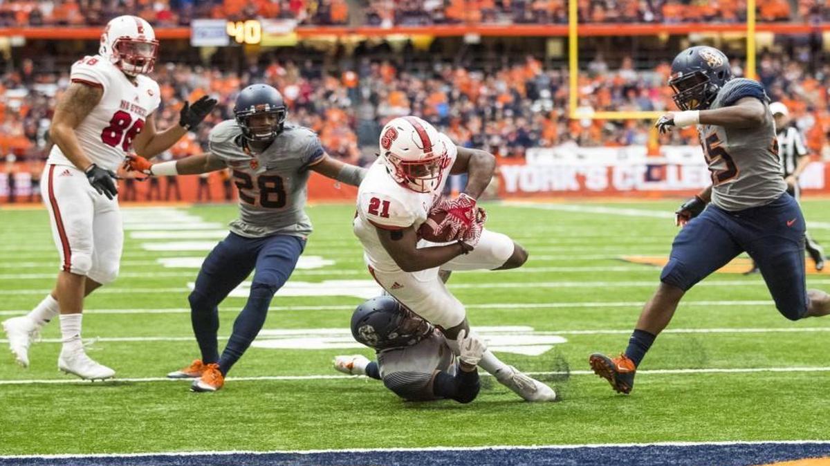 N.C. State’s Matthew Dayes dives into the end zone for a touchdown during the first half against the Syracuse Orange at The Carrier Dome in Syracuse, N.Y.