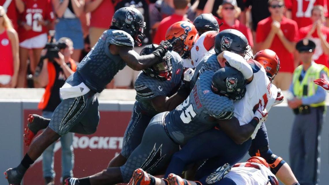 On fourth and one with 7:47 left in the second quarter, N.C. State’s Kentavius Street (35) and the defense stop Syracuse quarterback Eric Dungey (2) for no gain during the Wolfpack’s victory at Carter-Finley Stadium in Raleigh Saturday, Sept. 30, 2017.