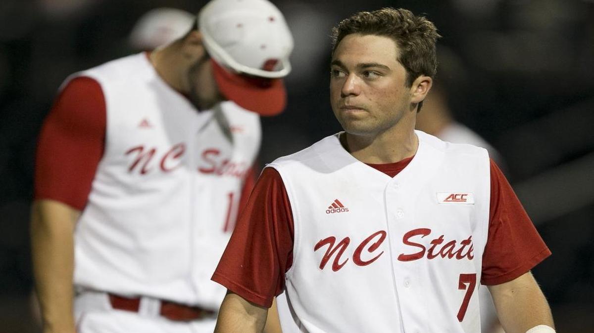 N.C. State’s Stephen Pitarra (7) checks the scoreboard as leaves the field with Shane Shepard (16) following the Wolfpack’s 8-7 loss to Miami during the ACC Baseball Championship Tournament on Thursday.