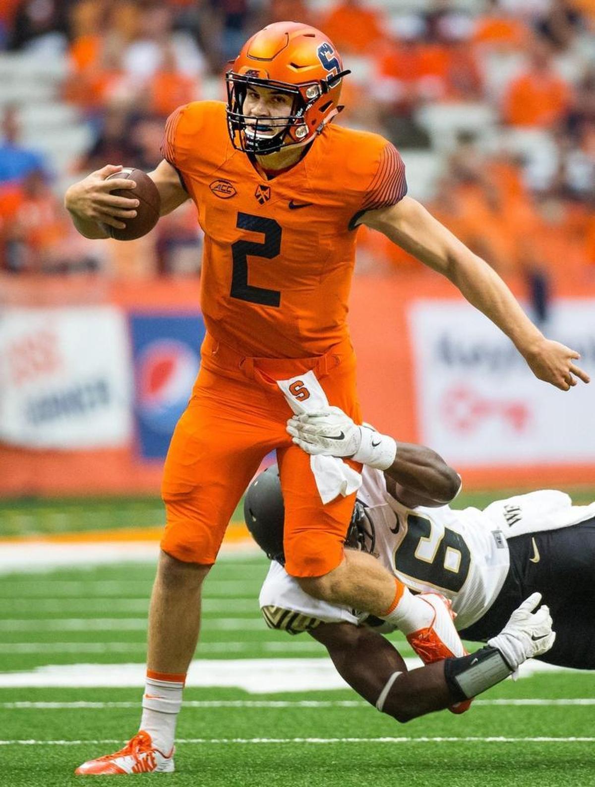 Eric Dungey #2 of the Syracuse Orange is tackled by Thomas Brown #26 of the Wake Forest Demon Deacons on September 12, 2015 at The Carrier Dome in Syracuse, N.Y. (Photo by Brett Carlsen/Getty Images)