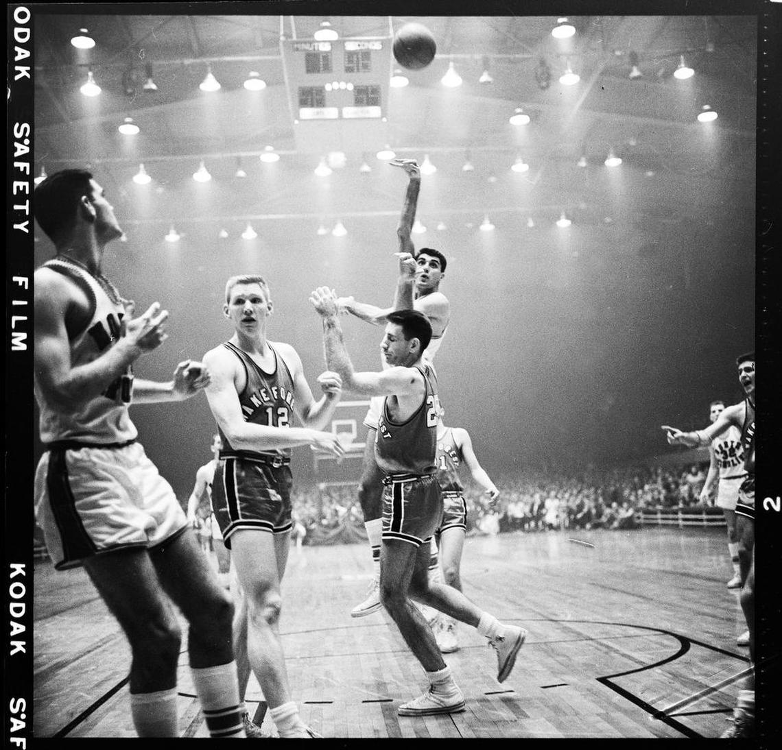 Lennie Rosenbluth shoots over Wake Forest defenders in the 1957 ACC Tournament. A haze of cigarette smoke hangs in the air -- smoking wasn’t banned in arenas until decades later.