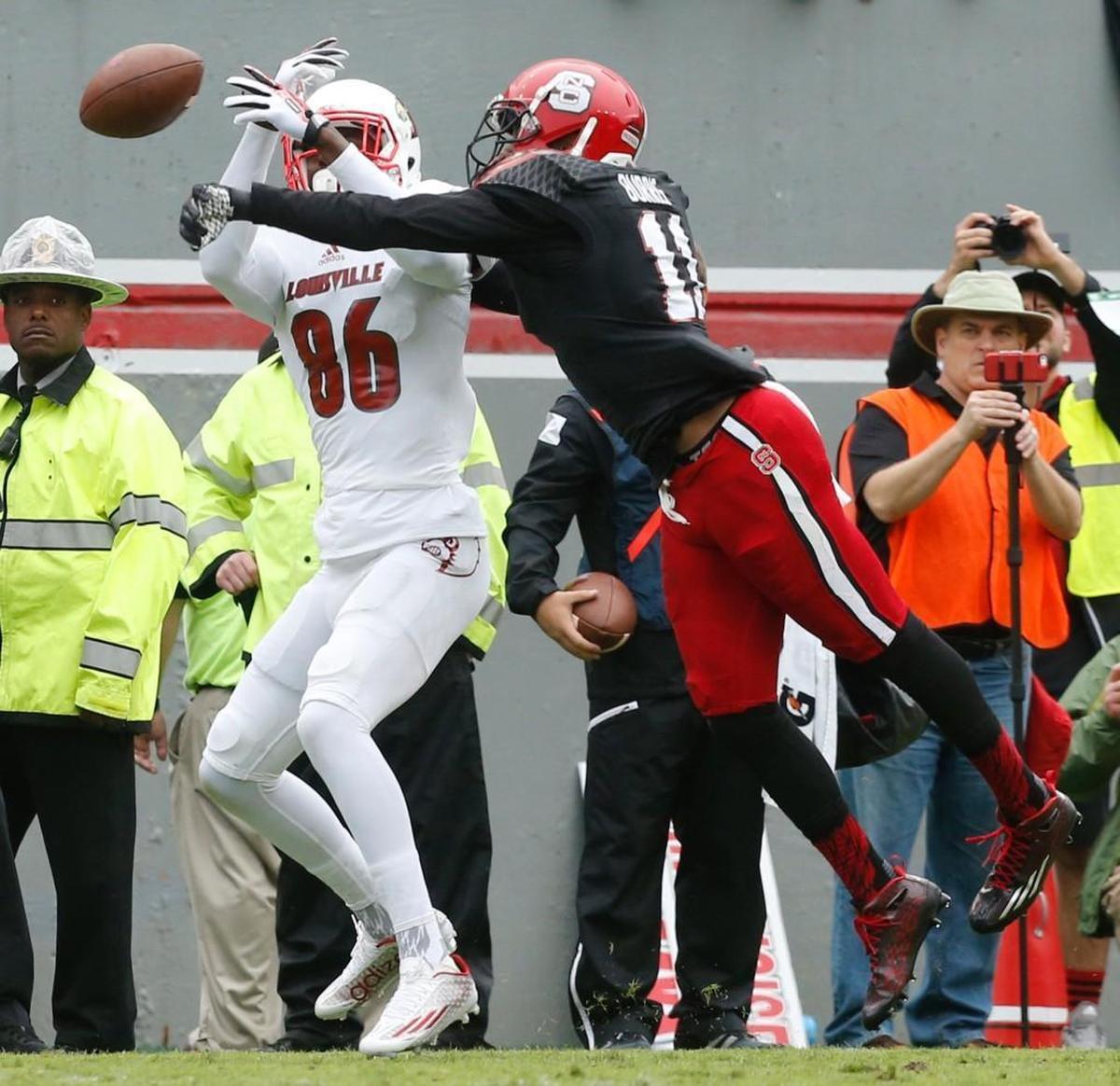 N.C. State’s Juston Burris (11) breaks up a pass intended for a Louisville wide receiver in 2015. Burris has agreed to a two-year deal to play for the Carolina Panthers.