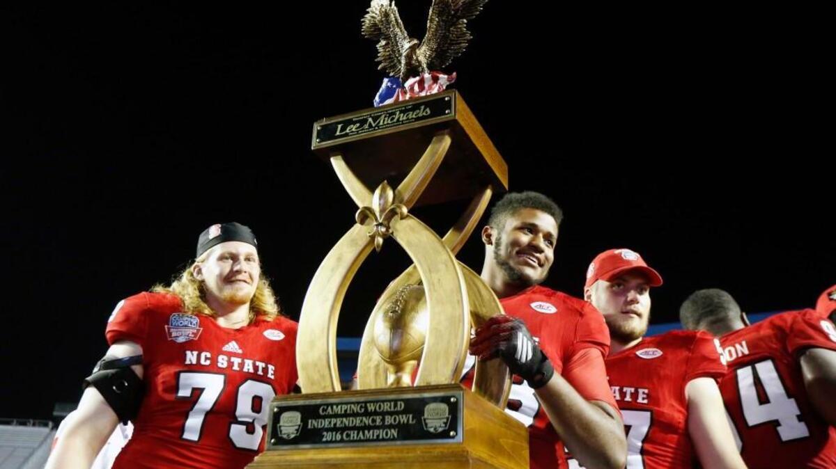 North Carolina State players hoist the winners trophy after defeating Vanderbilt in the Camping World Independence Bowl NCAA college football game in Shreveport, La., Monday, Dec. 26, 2016. North Carolina State won 41-17.