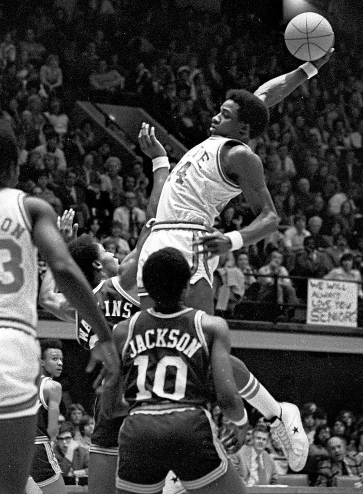 NC State’s David Thompson soars during his final home game in Reynolds Coliseum against UNC-Charlotte March 2, 1975.