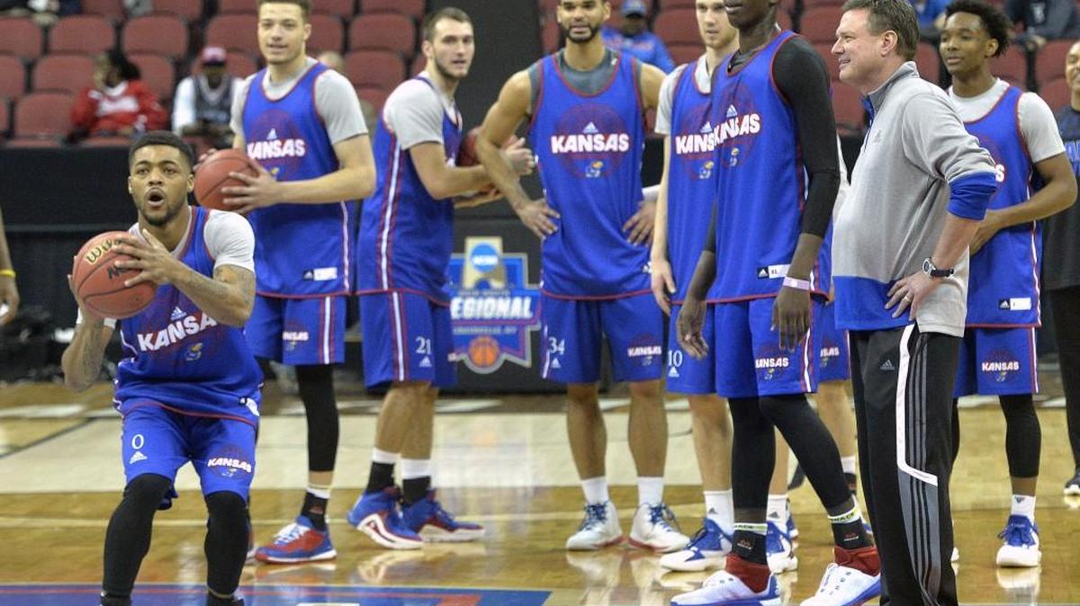 Kansas guard Frank Mason (0) attempts a half court shot as Kansas head coach Bill Self looks on during a practice in Louisville, Ky. on Wednesday. Kansas plays against Maryland in the Sweet 16 Thursday at 9:40 p.m.