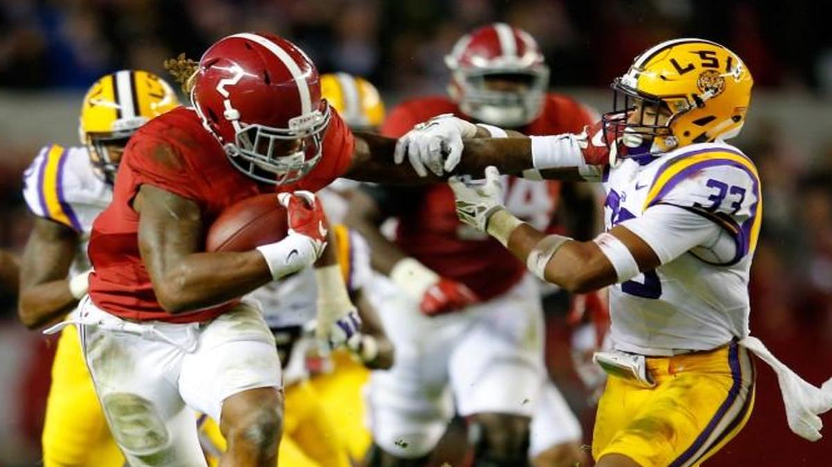 Derrick Henry of the Alabama Crimson Tide rushes away from Louisiana State’s Jamal Adams (33) in the second quarter at Bryant-Denny Stadium on Saturday in Tuscaloosa, Ala.